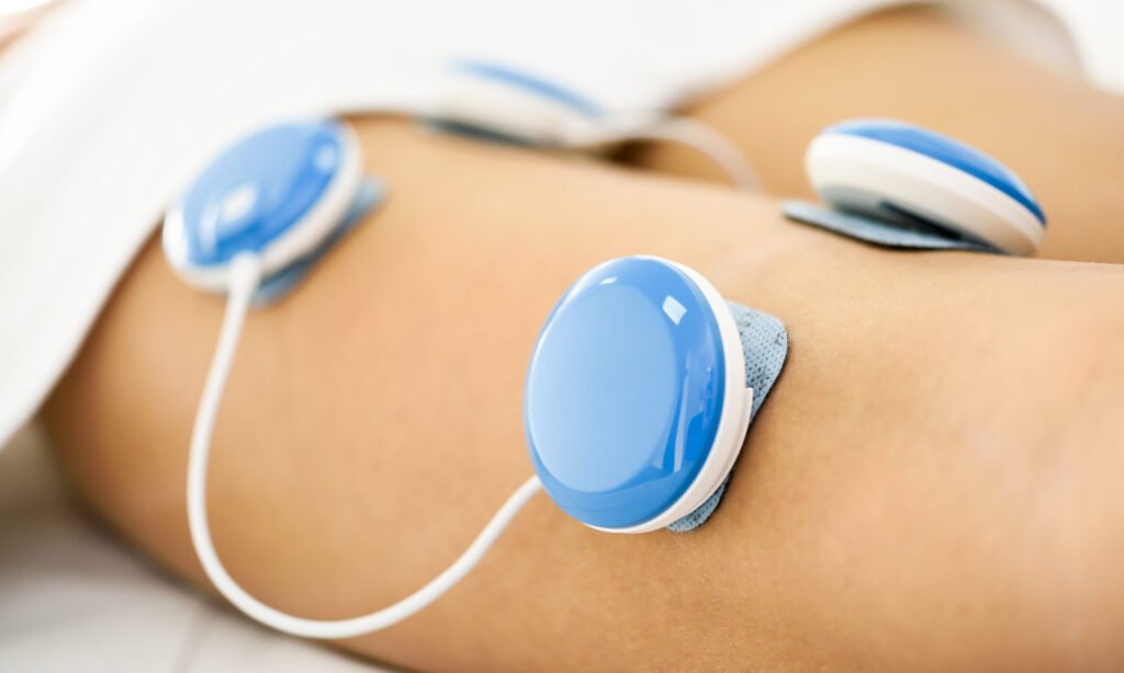 Electro stimulation in physical therapy to a young woman. Medical check at the leg in a physiotherapy center.